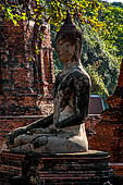 Ayutthaya, Thailand. Wat Mahathat, the Buddha statue of a small vihara with a chedi near the eastern side of the eclosure. 